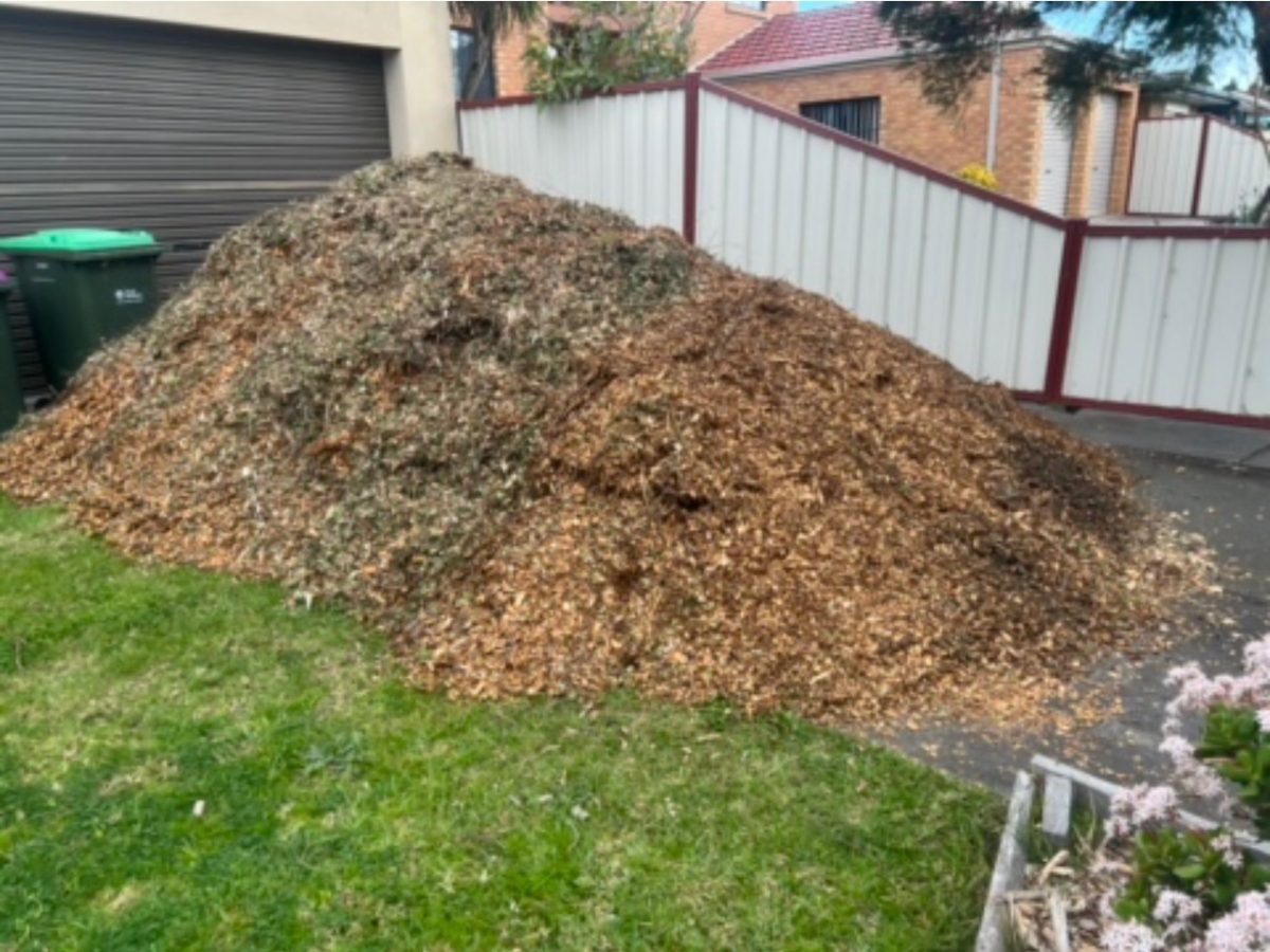 Driveway mulch deliveries with mixed green and brown chips