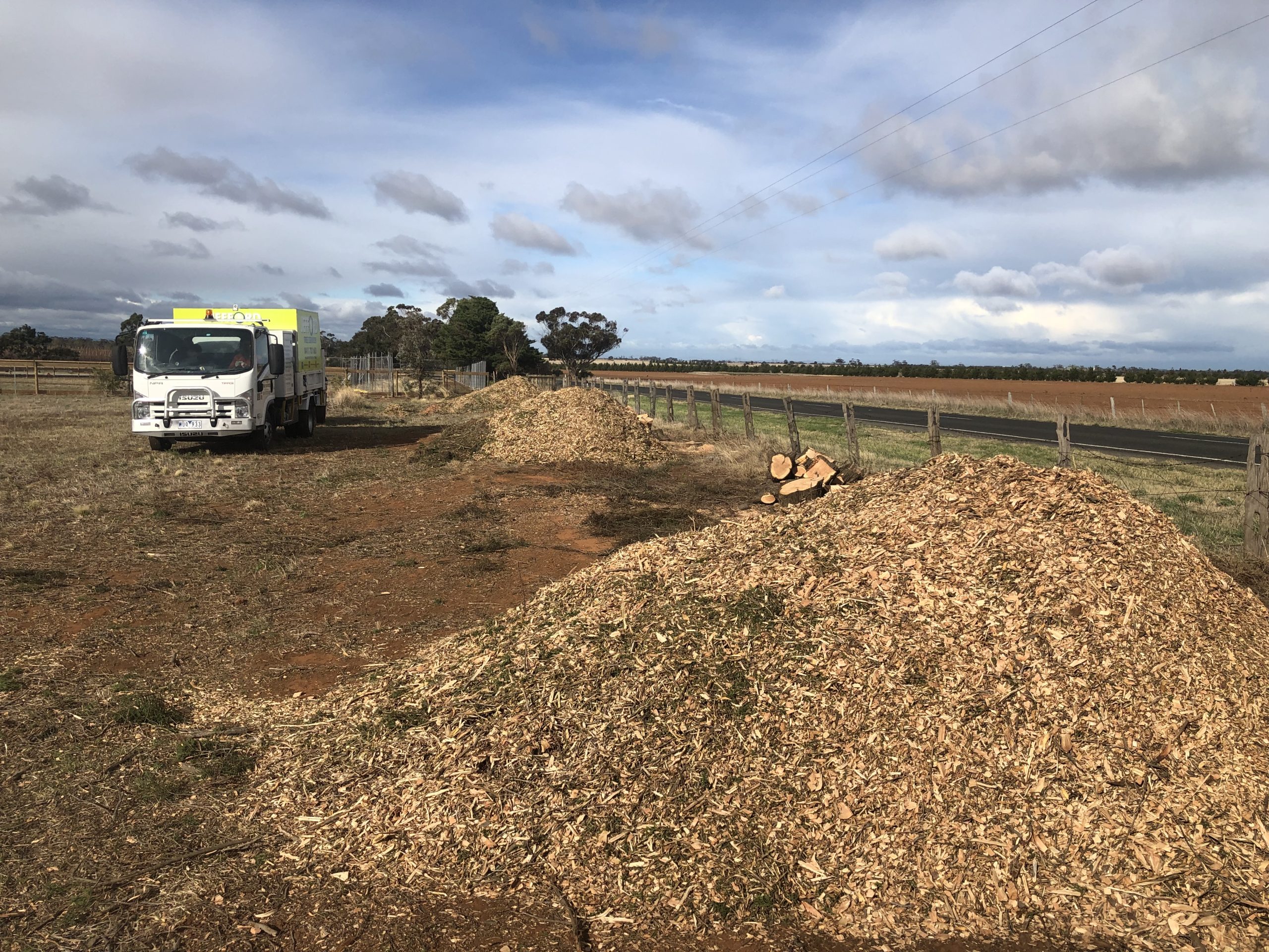 Rural property mulch deliveries beside a tipper truck
