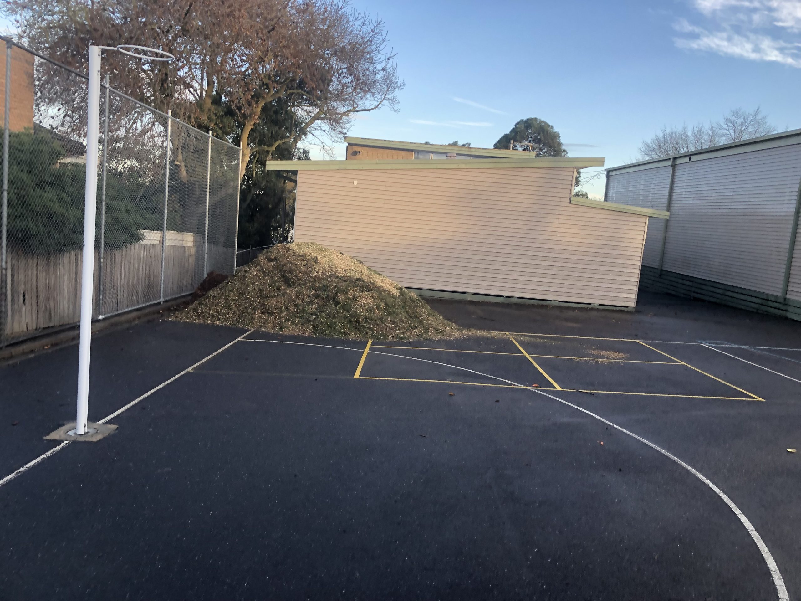 Community site mulch deliveries on a sports court