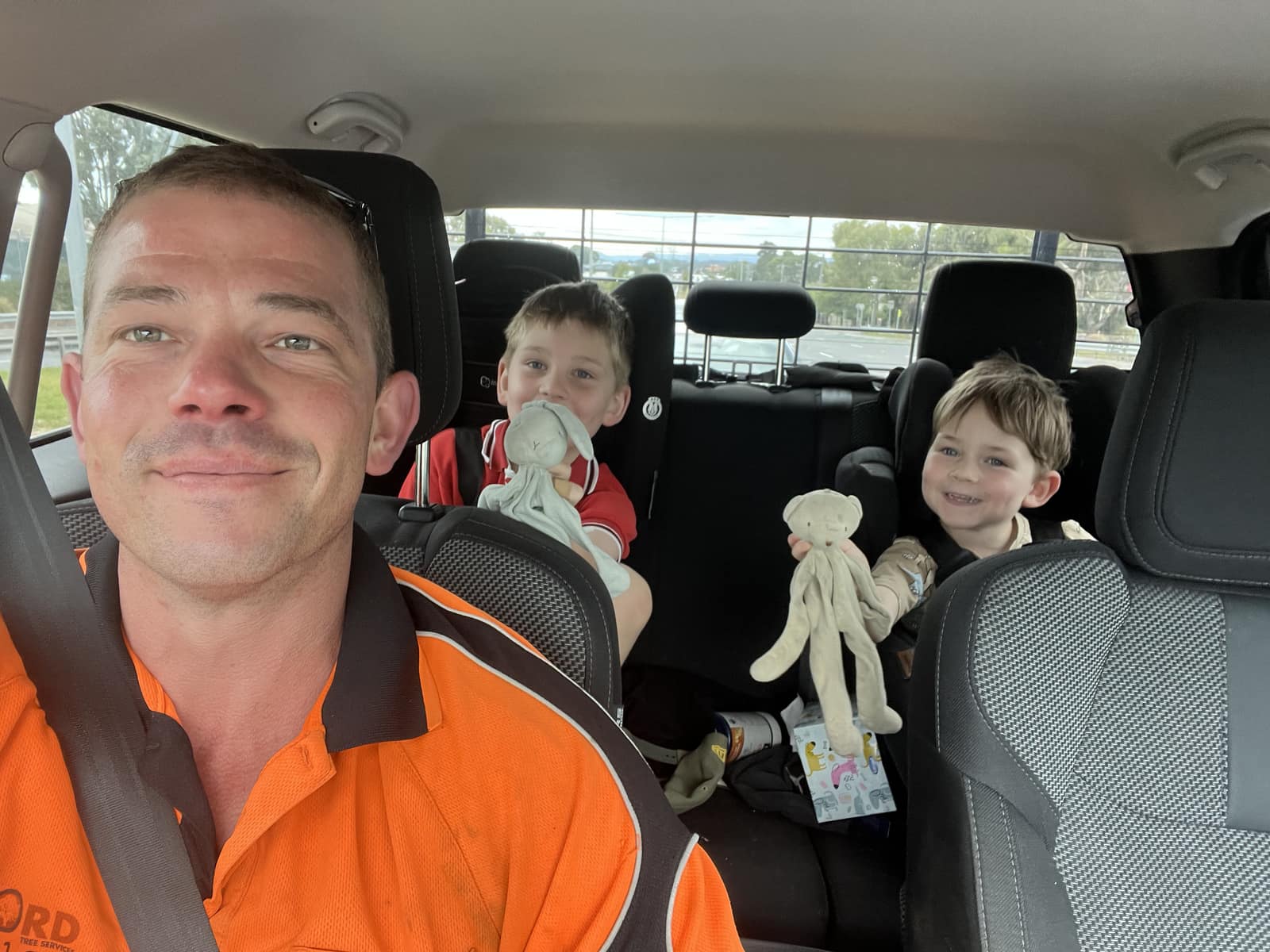 Pete Jefford in high-vis with his two sons in the work ute